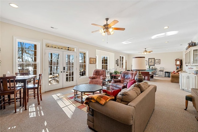 living room with french doors, billiards, ceiling fan, ornamental molding, and light colored carpet