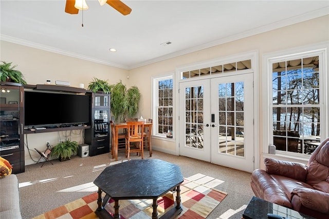 living room featuring carpet flooring, ceiling fan, ornamental molding, and french doors