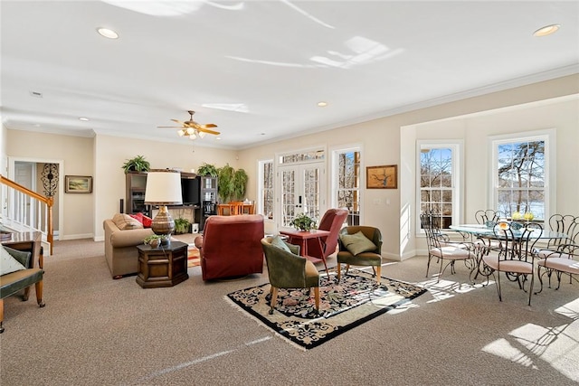 carpeted living room with ceiling fan, ornamental molding, and french doors