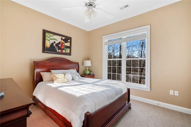 carpeted bedroom featuring ceiling fan and crown molding