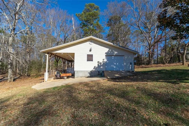 view of home's exterior featuring a lawn, an outbuilding, and a garage