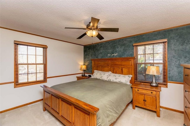 carpeted bedroom featuring multiple windows, ceiling fan, a textured ceiling, and ornamental molding