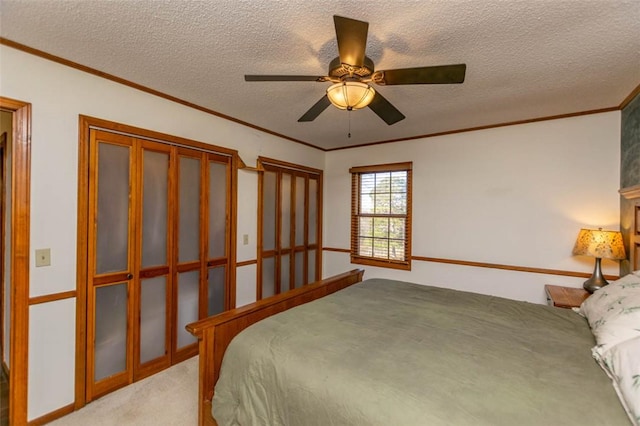 carpeted bedroom with ceiling fan, crown molding, and a textured ceiling