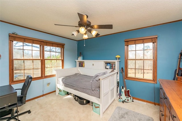 bedroom featuring multiple windows, ceiling fan, crown molding, and light colored carpet