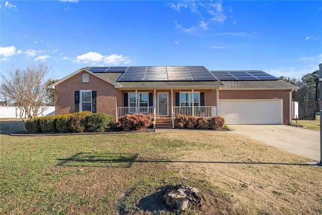 single story home featuring a front yard, covered porch, a garage, and solar panels