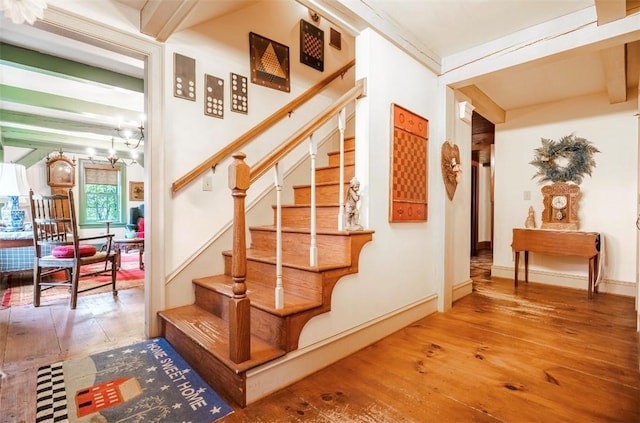 staircase with hardwood / wood-style flooring and baseboards