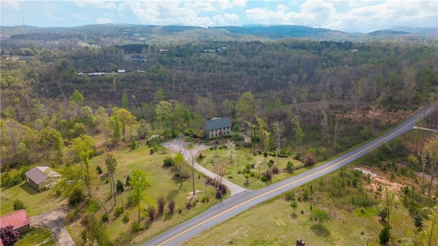 drone / aerial view featuring a forest view