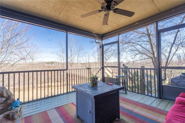 sunroom / solarium featuring ceiling fan
