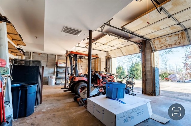 garage with concrete block wall and visible vents