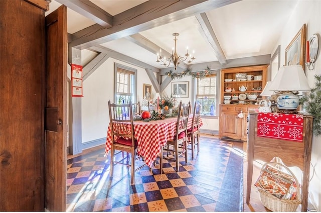 dining space with a chandelier, beam ceiling, tile patterned floors, and baseboards