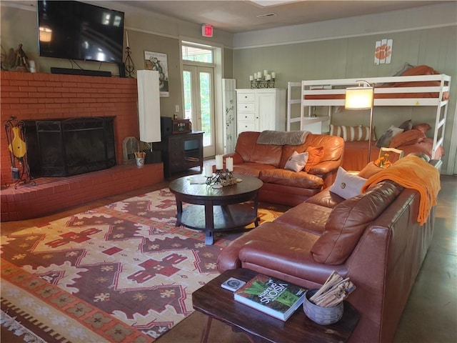 living room with a brick fireplace