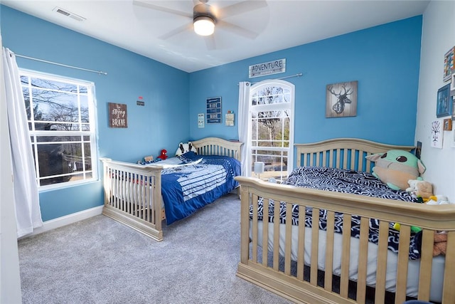 bedroom featuring carpet flooring, multiple windows, and ceiling fan