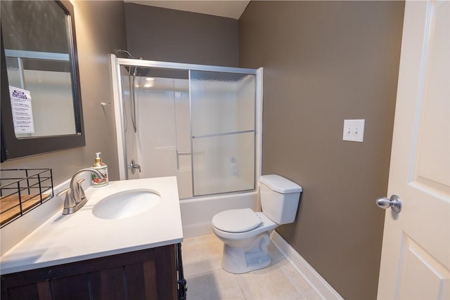 full bathroom with tile patterned flooring, toilet, vanity, and combined bath / shower with glass door