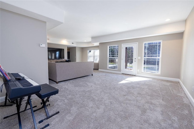 unfurnished living room featuring light colored carpet