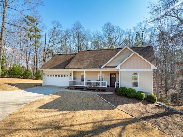 view of front of home featuring covered porch and a garage