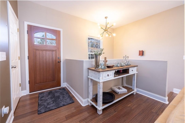 entrance foyer with dark hardwood / wood-style floors and a chandelier