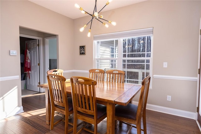 dining area with dark hardwood / wood-style floors and a chandelier