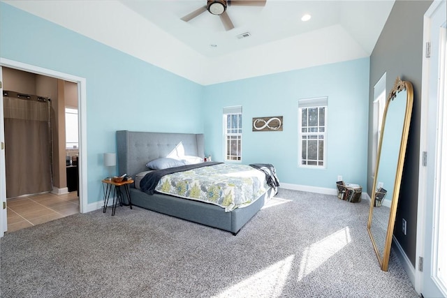 bedroom featuring light colored carpet, ceiling fan, and a tray ceiling