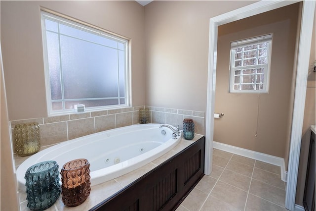 bathroom with a tub to relax in and tile patterned floors