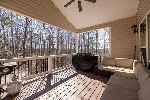 wooden terrace featuring an outdoor living space, area for grilling, and ceiling fan