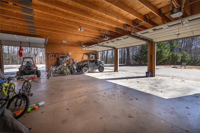 snow covered garage with a garage door opener