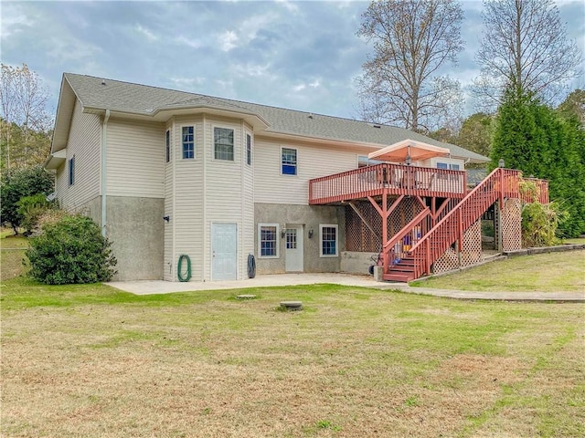 rear view of property with a deck and a yard