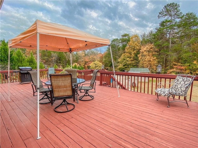 wooden terrace with a grill