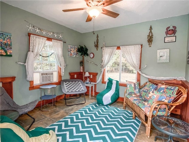 living area featuring tile patterned floors, ceiling fan, and cooling unit