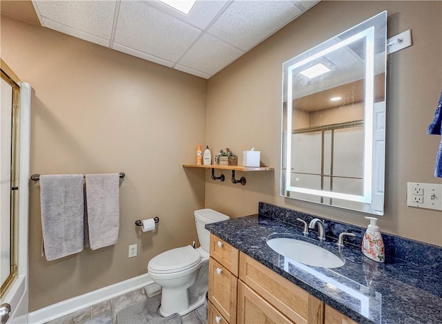 bathroom featuring vanity, a paneled ceiling, and toilet