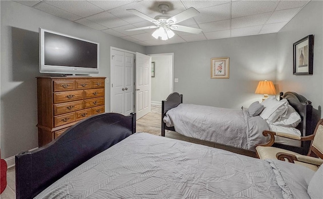 bedroom featuring a paneled ceiling, ceiling fan, and light hardwood / wood-style floors