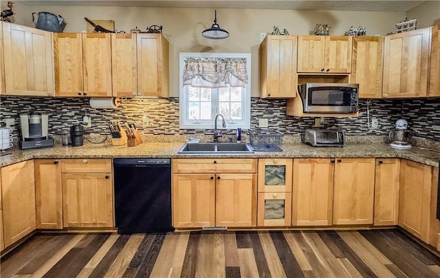 kitchen with dark hardwood / wood-style flooring, sink, light stone counters, and black dishwasher