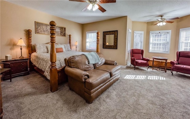 bedroom featuring multiple windows, a textured ceiling, and ceiling fan