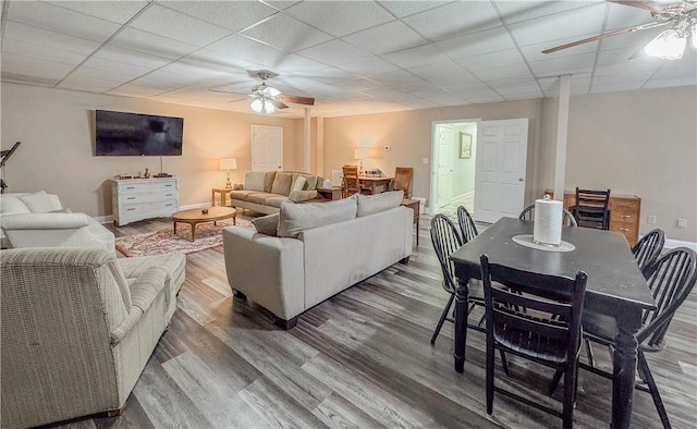 living room with a paneled ceiling, ceiling fan, and hardwood / wood-style floors