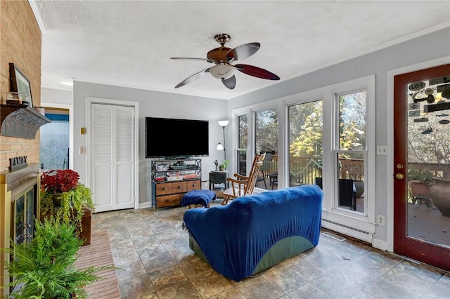 living room with a baseboard radiator, a fireplace, and ceiling fan