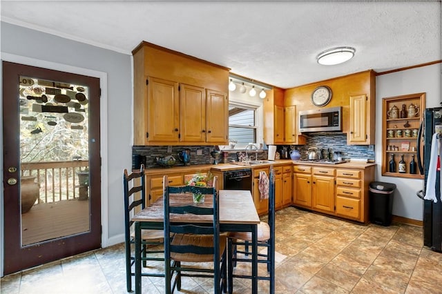 kitchen with ornamental molding, sink, decorative backsplash, and black appliances