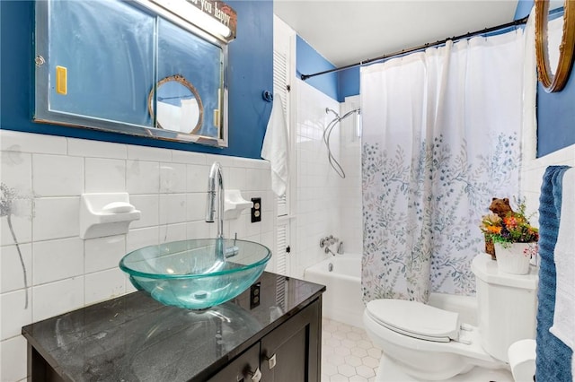 full bathroom featuring shower / bath combo with shower curtain, vanity, toilet, and tile walls