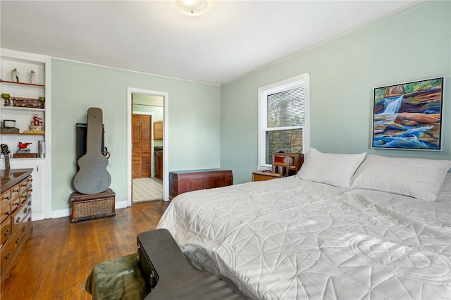 bedroom featuring dark hardwood / wood-style flooring and ensuite bath