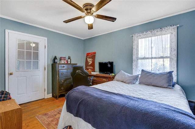 bedroom featuring hardwood / wood-style flooring, ceiling fan, and crown molding