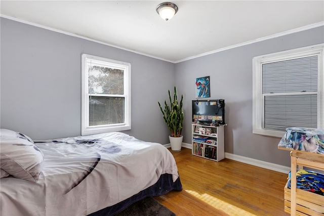 bedroom featuring hardwood / wood-style flooring and ornamental molding