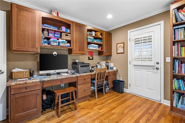 home office featuring built in desk, light hardwood / wood-style flooring, and crown molding