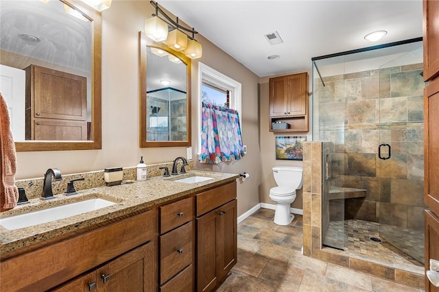 bathroom featuring vanity, toilet, and a shower with door