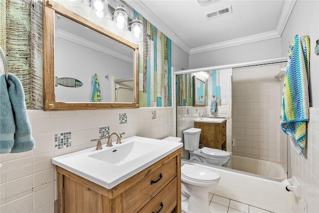 full bathroom featuring vanity, crown molding, tiled shower / bath combo, toilet, and tile walls