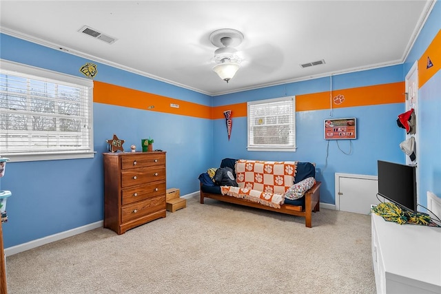 sitting room with a wealth of natural light, crown molding, carpet floors, and ceiling fan