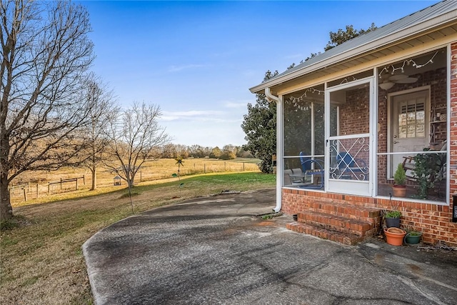 view of patio featuring a sunroom