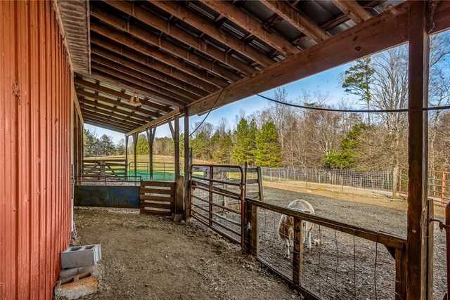 view of horse barn with a rural view