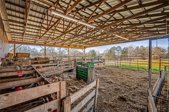 view of horse barn with a rural view