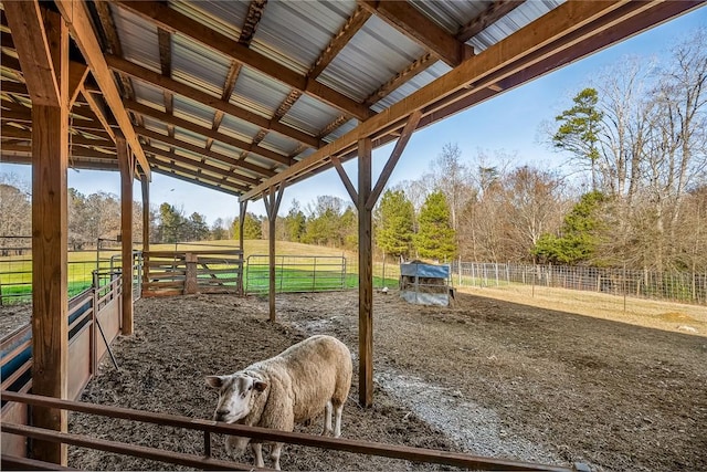 view of horse barn featuring a rural view