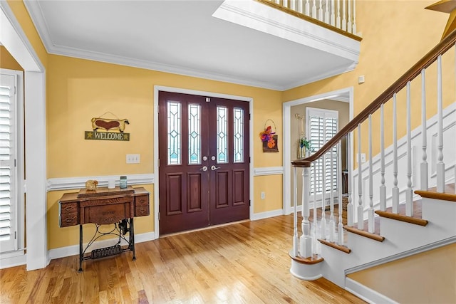 entrance foyer featuring light hardwood / wood-style floors and crown molding