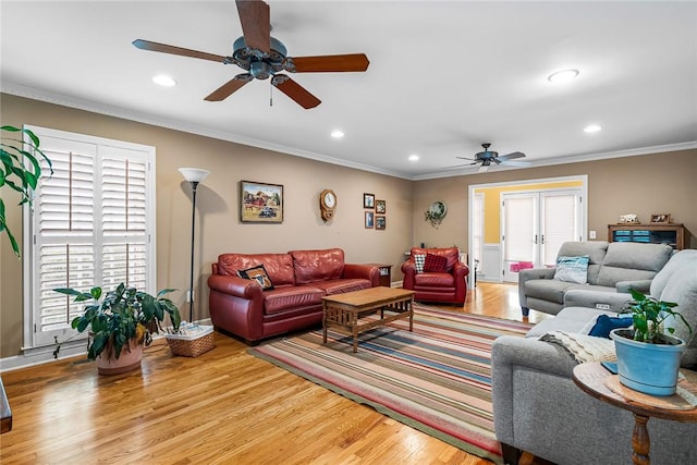 living room featuring ceiling fan, light hardwood / wood-style flooring, plenty of natural light, and ornamental molding