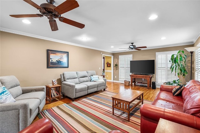 living room with ceiling fan, light hardwood / wood-style floors, and ornamental molding